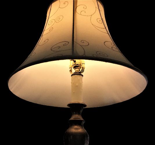 Beeswax candle sleeve on table lamp with shade