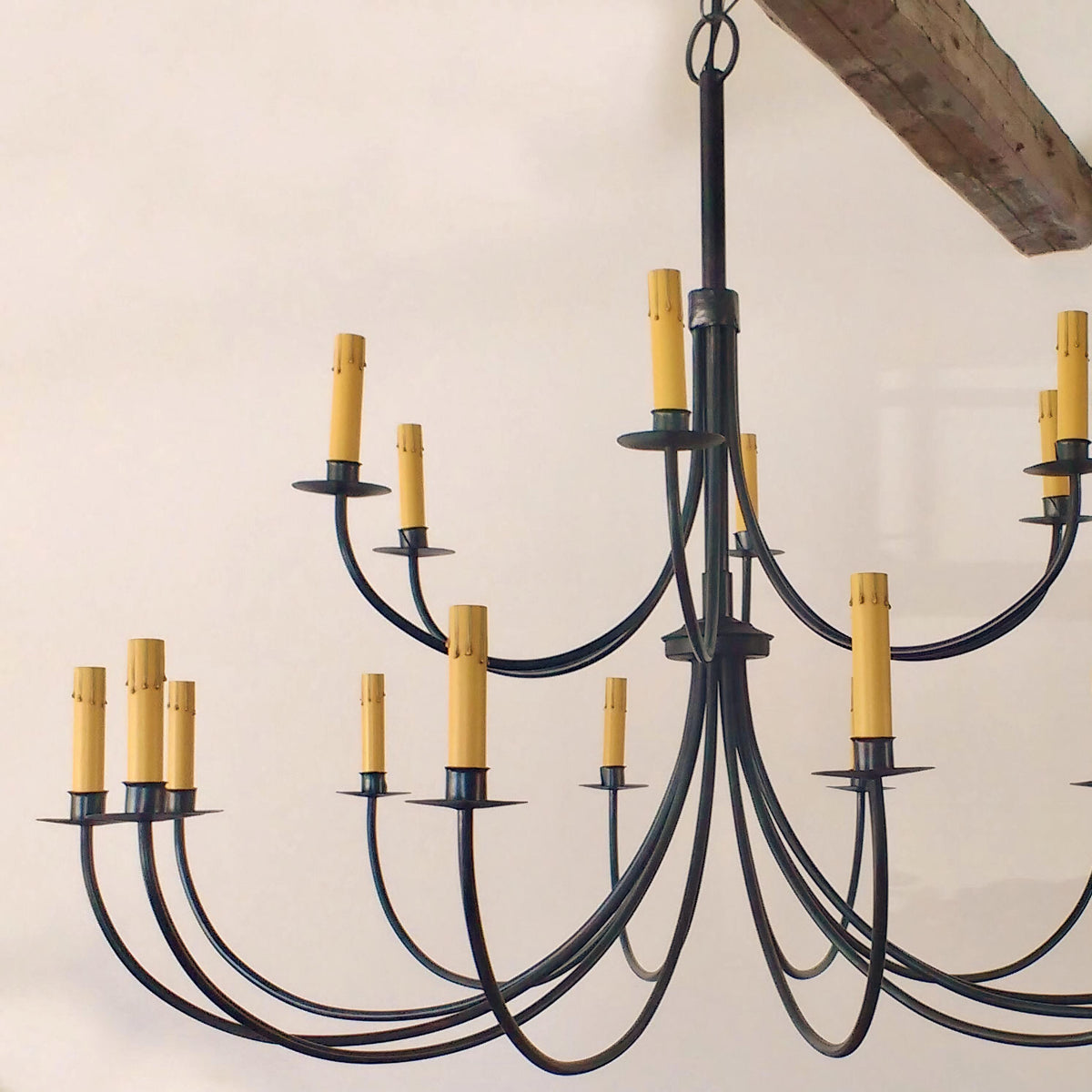 Gold cardboard candle covers on chandelier